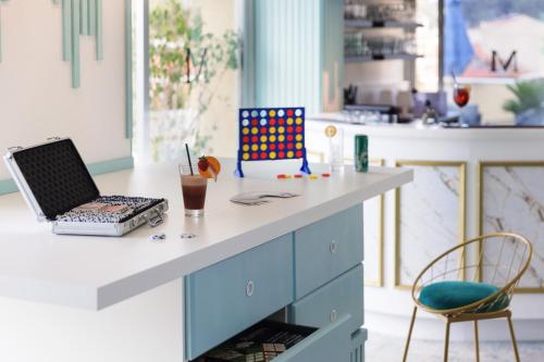 a kitchen with a counter with a laptop on it at Best Western Hotel Mediterranee Menton in Menton