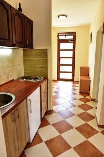 a kitchen with a checkered floor with a sink at Apartments Mirko in Ulcinj