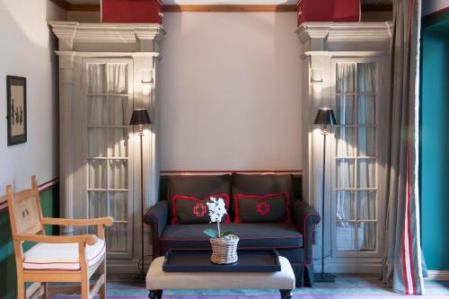 a living room with a couch and a table at House of Hütter - Wachtelhof & SPA in Maria Alm am Steinernen Meer