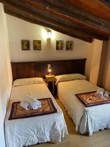 a bedroom with two beds with towels on them at CASA RURAL VICENTA 1750 in Albentosa