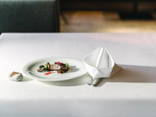 a plate of food on a table with a napkin at Das König Ludwig Inspiration SPA in Schwangau