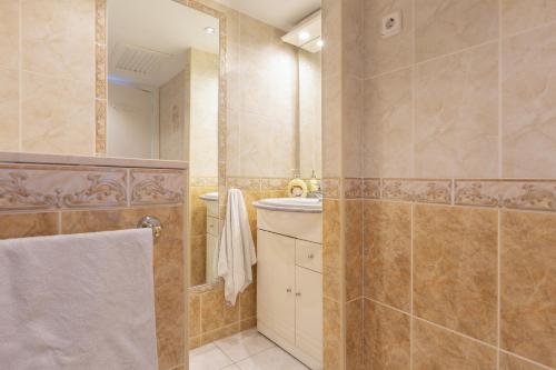 a bathroom with a shower and a sink and a mirror at Marina view apartment in Fuengirola