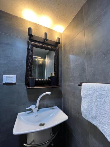 a bathroom with a sink and a mirror at Diamond Studio Apartment - Haifa in Haifa