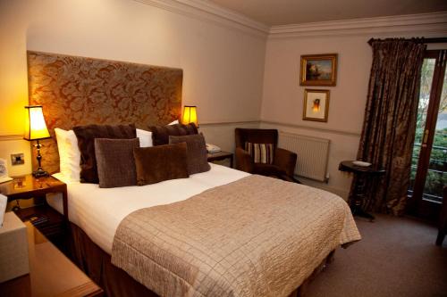 a hotel room with a bed and a desk and chair at Whitley Hall Hotel in Chapeltown