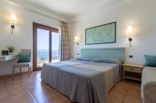 a hotel room with a bed and a balcony at Hotel Brancamaria in Cala Gonone