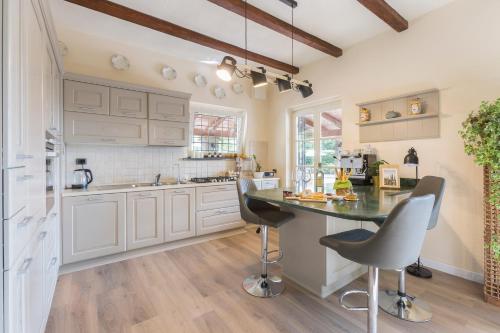 a kitchen with white cabinets and a black counter top at White Tail Organic Farm in Orsara Bormida