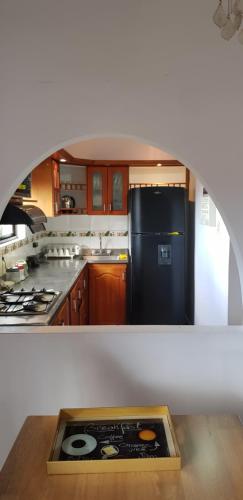 cocina con nevera negra y fogones en Wonderful house with views in Medellin-fiber optics, en Medellín