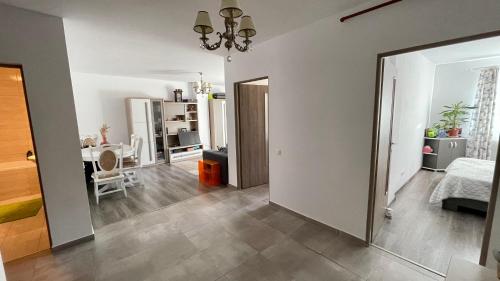 a living room with a mirror and a bedroom at Central Quick, private parking in Cluj-Napoca