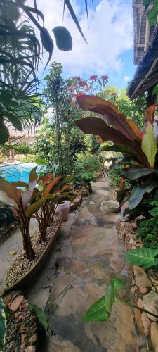 a garden with plants and a stream of water at Salama & Mbuyuni Bungalows in Matemwe