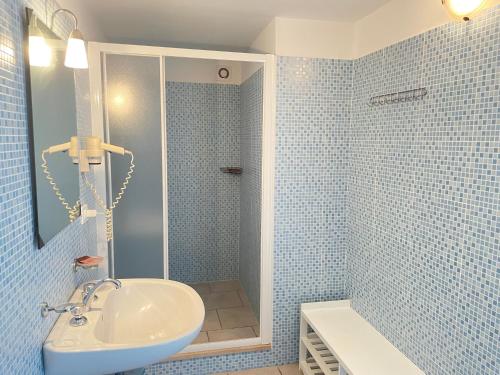 a blue tiled bathroom with a sink and a shower at GALLIPOLI DUESTANZE in Gallipoli