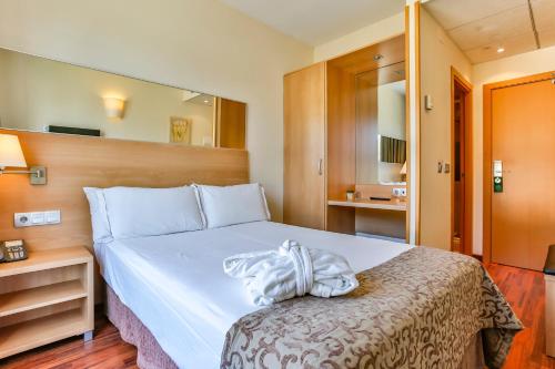a hotel room with a bed with a towel on it at Hotel Desitges in Sant Pere de Ribes