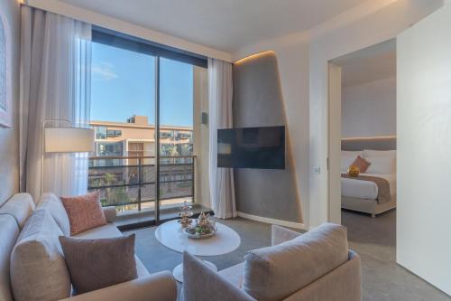 a living room with a couch and a large window at Pestana CR7 Marrakech in Marrakech