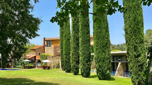 a row of trees in front of a building at Arcs De Monells - Adults Only in Monells