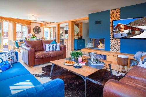 a living room with a couch and a table at Chalet Levant Blanc - OVO Network in Seytroux