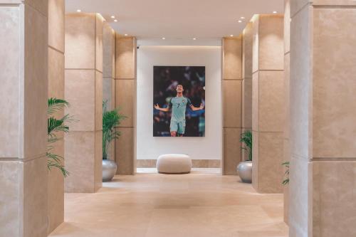 a hallway with a painting of a woman on the wall at Pestana CR7 Marrakech in Marrakech