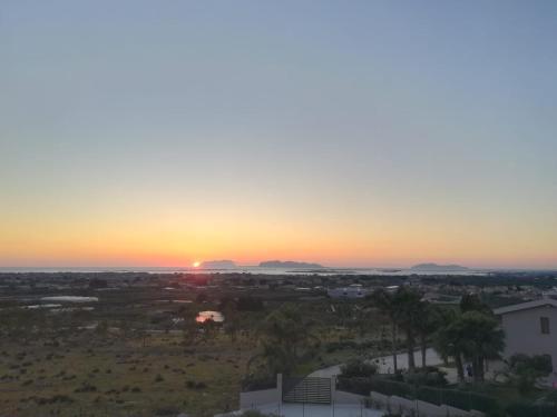 a sunset over the desert with mountains in the distance at A un Passo dal Tramonto in Marsala