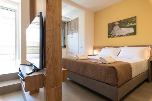 a bedroom with a bed and a television in it at Dimitra Central Apts in Chania Town