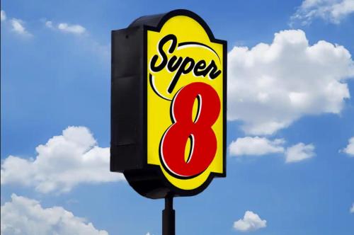 a sign for a super eight restaurant on a pole at Super 8 by Wyndham Fort Worth Entertainment District in Fort Worth