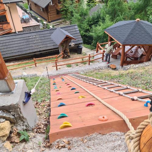 a model of a playground with a wooden bridge at Penzión Dúhový Pstruh in Bystrá