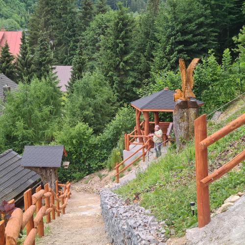 a model of a train on a hill with a wooden fence at Penzión Dúhový Pstruh in Bystrá