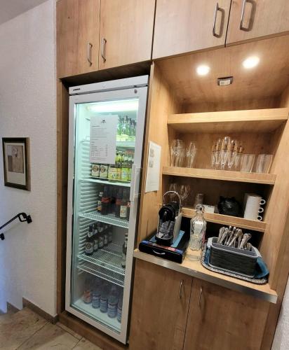 a refrigerator with its door open in a kitchen at Dreispitz -B&B-Hotel Garni in Hofheim am Taunus