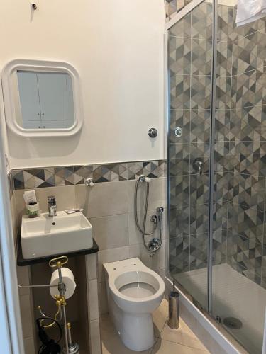 a bathroom with a shower and a toilet and a sink at Coral Blue Apartment in Piano di Sorrento