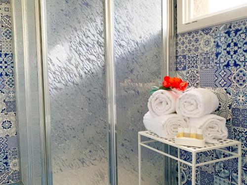 a bunch of towels on a shelf in a bathroom at Nonna Pasqualina in Panarea