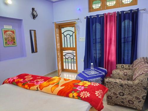 a room with a bed and a chair and a window at The Gangotri Homestay By Preet rS in Barkot