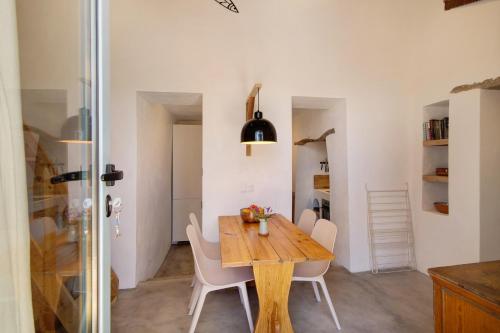 a kitchen and dining room with a wooden table and chairs at Casa Burro in Moncarapacho