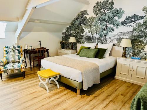 a bedroom with a large bed and a desk at Manoir de Beaupré in Vannes