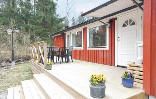 a deck with a red and white house at Nice Home In Lilla Edet With Wifi in Lilla Edet
