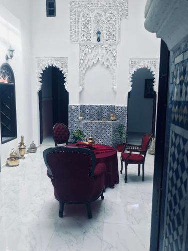 a room with a table and chairs in a building at Riad Al Ârâr in Rabat