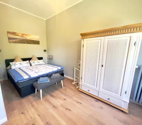 a bedroom with a blue bed and a closet at Gästehaus Sternschanze - App 3 Bootsmann in Stralsund