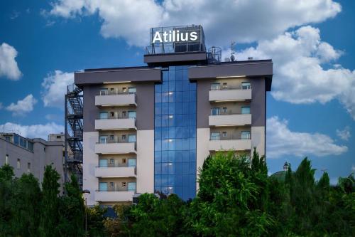 a building with a sign on top of it at Atilius Hotel & Suites in Riccione