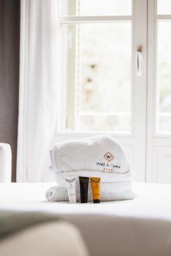a pile of towels sitting on a table next to a window at Hotel Well and Come Barcelona in Barcelona