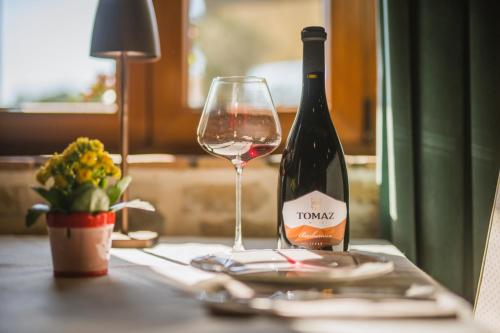a bottle of wine and a glass on a table at Ponte Porton Dining & lodging in Grožnjan