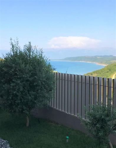 a fence with a view of a body of water at Duplex Seaview Condo in Durrës