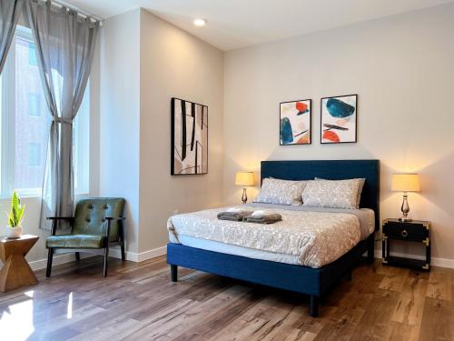 a bedroom with a blue bed and a chair at Stay at Luna on Ridge Ave in Philadelphia