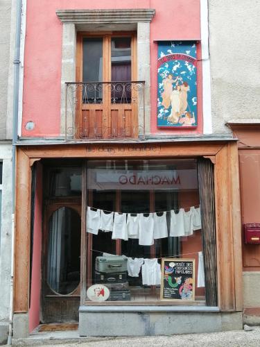 a building with a window with clothes hanging in it at File dans ta chambre ! in Le Monastier sur Gazeille