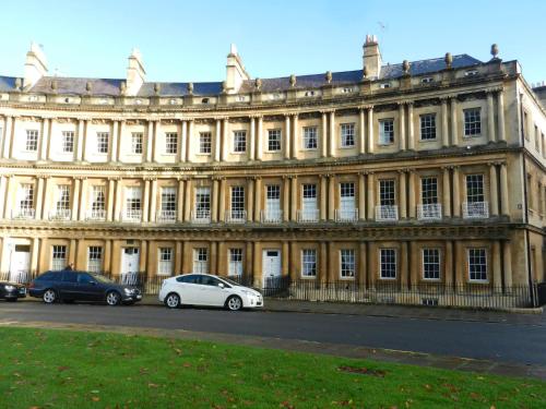 
a car parked in front of a large building at 18 The Circus Apartment in Bath
