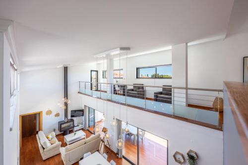 an open living room with a balcony with a pool at Pontalaia Village in Sagres
