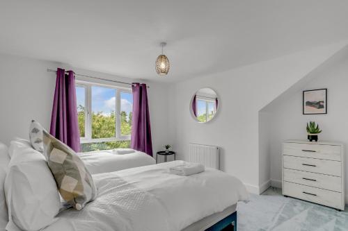 a white bedroom with two beds and a window at New Family & Contractor Home Lyhart Rd in Keswick