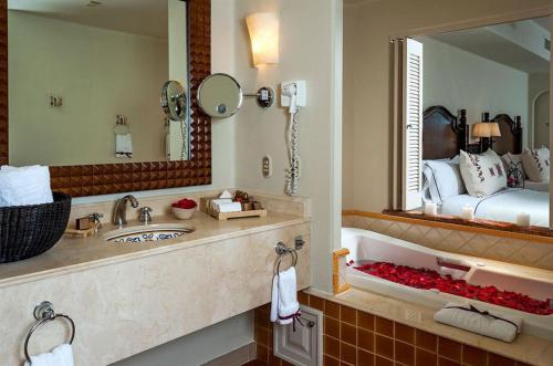 a bathroom with a sink and a large mirror at Suites at Hacienda Del Mar Resort Los Cabos in Cabo San Lucas