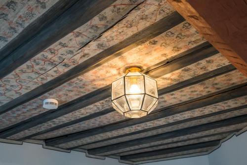 a lamp hanging from the ceiling of a room at Hotel-Restaurant Heiligenstadter Hof in Heiligenstadt