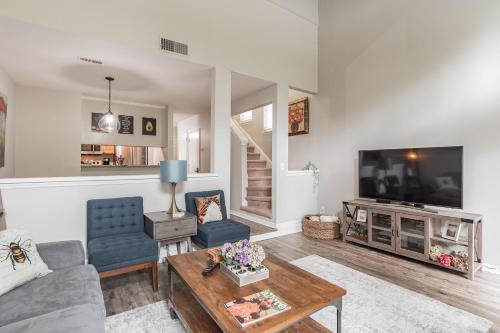 a living room with a couch and a tv at Modern Cozy Townhome in Charlotte