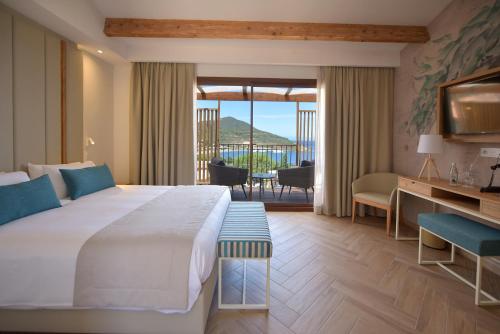 a hotel room with a large bed and a balcony at Hotel Palazzu & SPA - Adult Only in Galeria