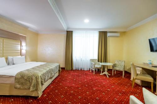 a hotel room with a bed and a desk at Hotel France in Vinnytsya