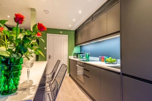 a kitchen with a vase of roses on a table at The Boutique York Garden Studio in York
