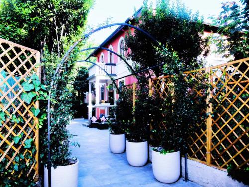 a group of potted plants in front of a house at La Villa bed & breakfast in Milan
