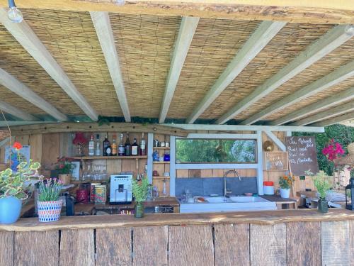 a kitchen with a counter in a wooden building at Cabane Bivouac avec échelle à l'ombre des chênes in Idrac-Respailles